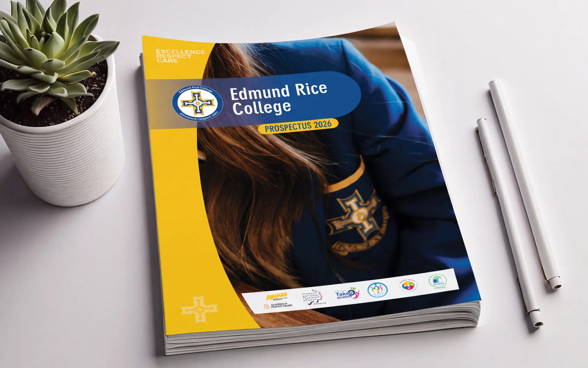 School prospectus book cover for Edmund rice college, pens and a plant